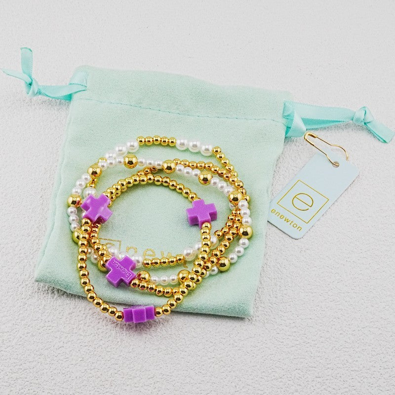 4-piece pearl and gold beaded stackable bracelets with purple cross charms