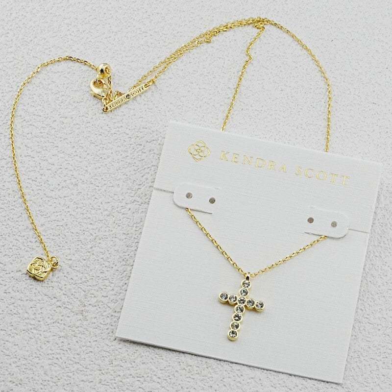 Gold cross pendant necklace with round diamond-studded cluster design and link chain