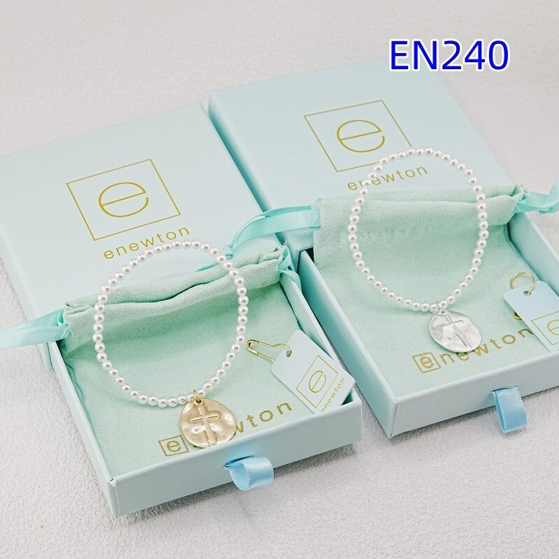 Two pearl strand charm bracelets with disc cross medallions in gold and silver tones