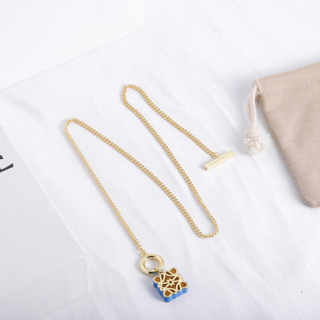 Gold-tone chain necklace with blue enamel square cutout logo pendant