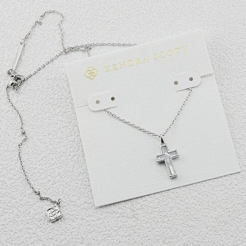 Silver cross pendant necklace with opal-like center and link chain