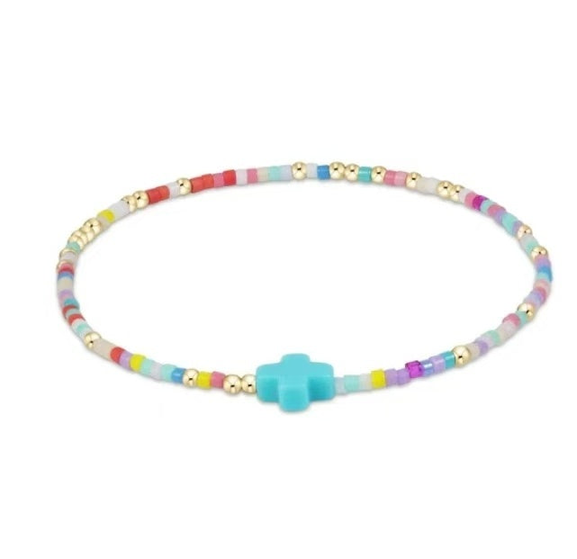 Colorful glass bead bracelet with blue cross charm and gold-tone spacer beads