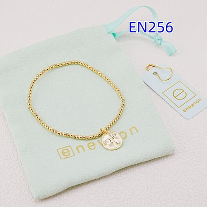 Gold-tone beaded bracelet with heart disc cross pendant and small clasp links