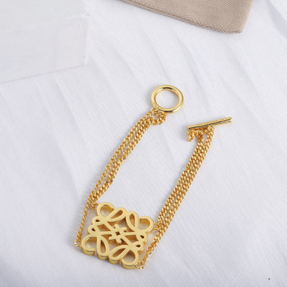 Gold LOEWE square cutout logo bracelet with square openwork logo charm