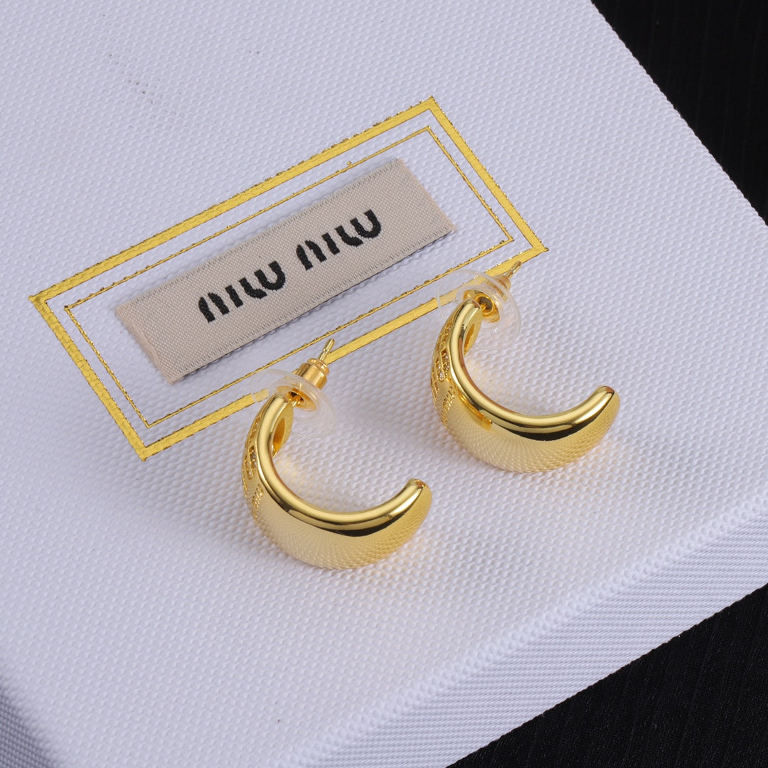 Gold glossy C-shaped metal hoop earrings, curved front with logo detail