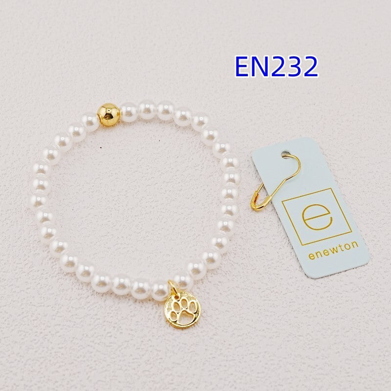 White pearl bead bracelet with gold accent bead and gold paw-print charm