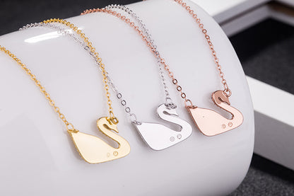 Iconic swan necklace: gold, silver & rose-gold pendants on chains.