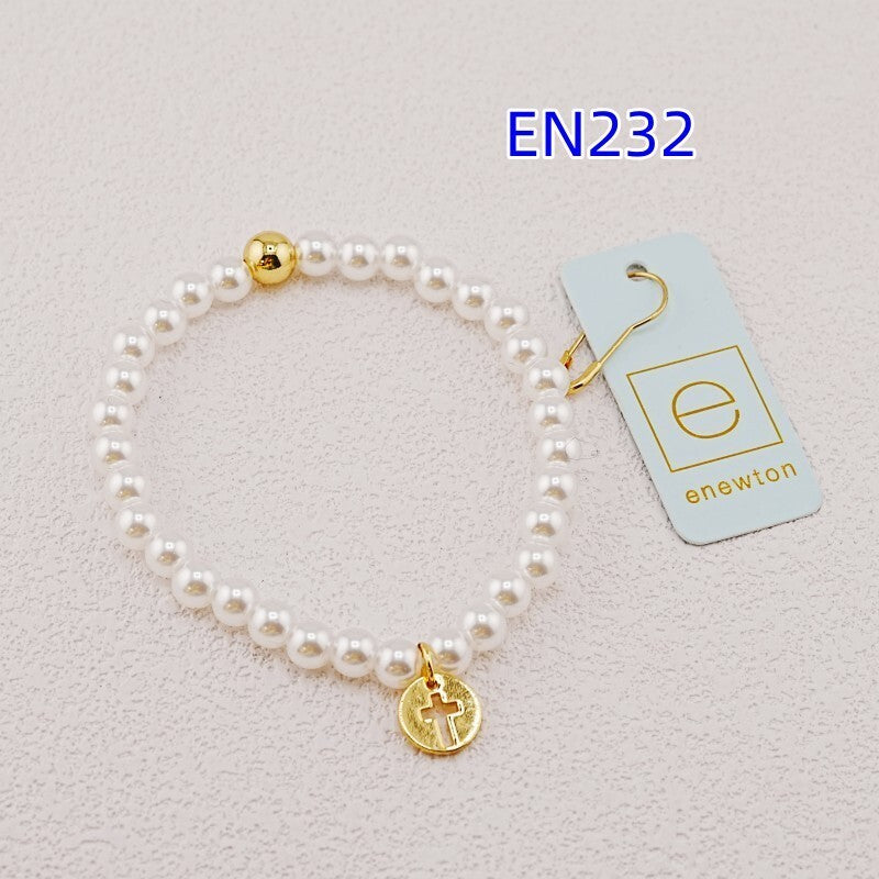 White pearl bead bracelet with gold accent bead and gold cross charm