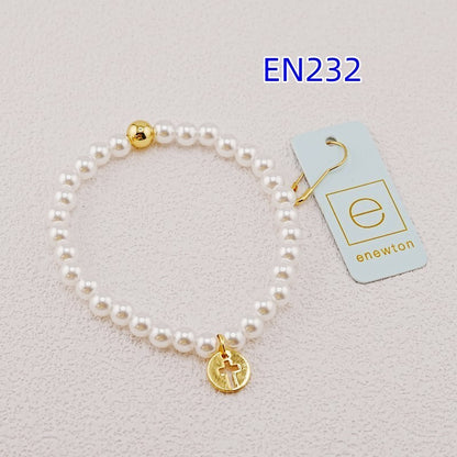 White pearl bead bracelet with gold accent bead and gold cross charm