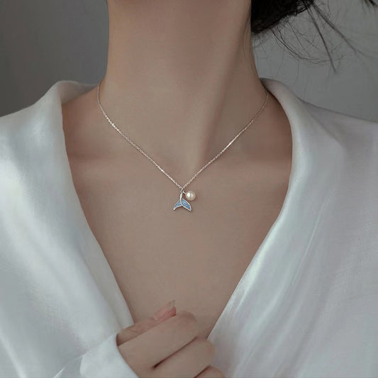 blue tail with pearl necklace