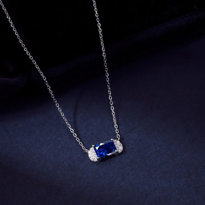 Shimmering Silver Station Necklace with Central Blue Gem and Winged Halos

