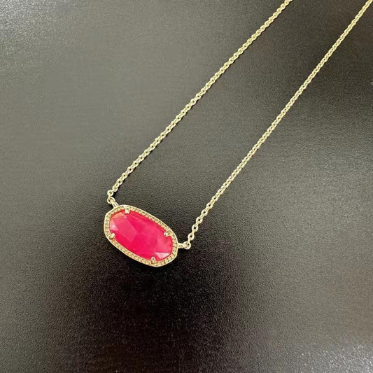 Teardrop pendant necklace with gold-tone chain and pink teardrop pendant