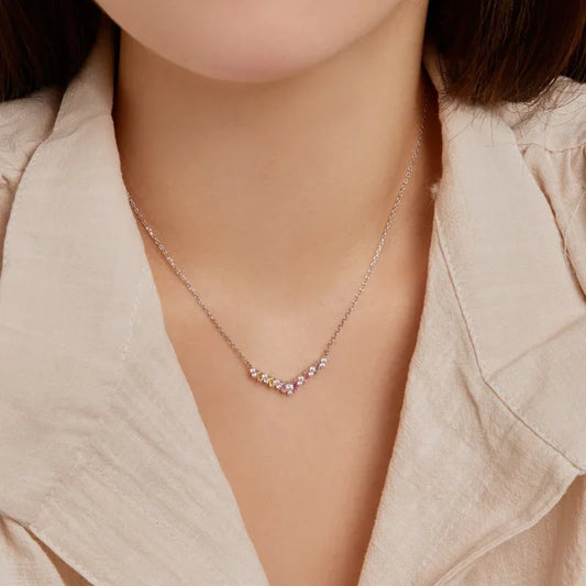 V-shaped CZ pendant necklace with pink center stones and clear accents on a silver chain