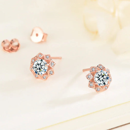 Rose gold diamond stud earrings with round center stone and small gem halo