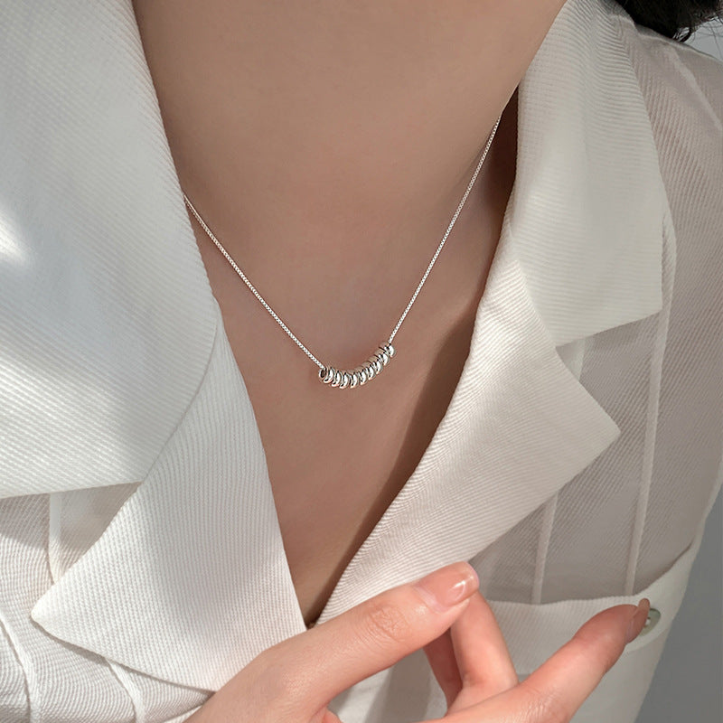 Silver Bead Arc Necklace (assuming silver-colored beads)


