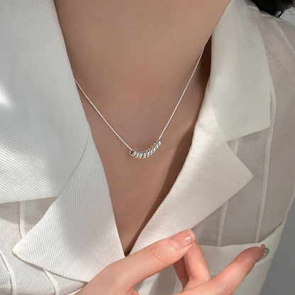 Silver Bead Arc Necklace (assuming silver-colored beads)

