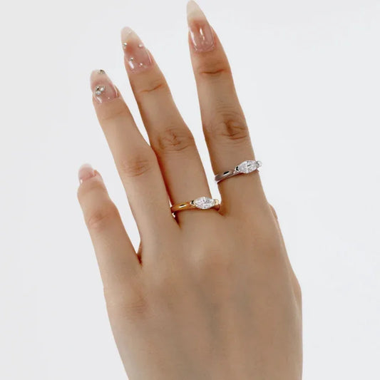 White gold band ring with oval marquise CZ solitaire on finger