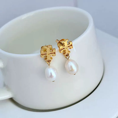 Gold-tone stud earrings with dangling white pearl drops and ornate square settings