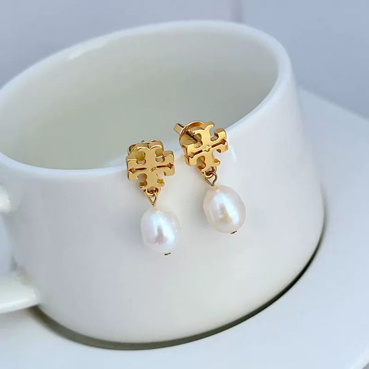Gold-tone stud earrings with dangling white pearl drops and ornate square settings