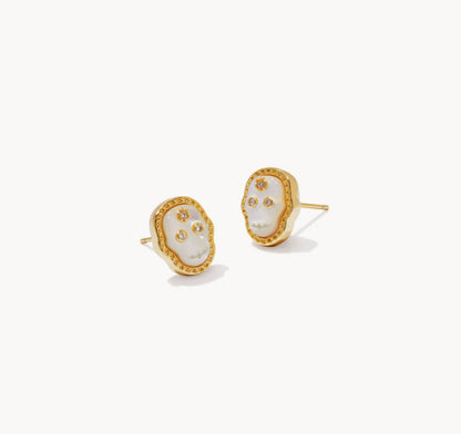 Gold stud earrings with white skull faces and small clear gem accents