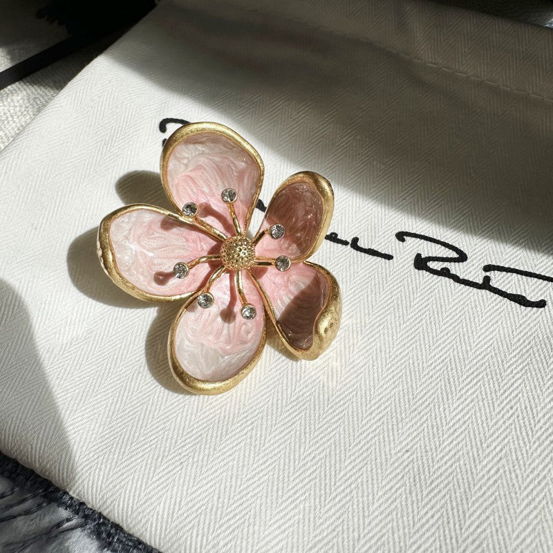Pink enamel cherry blossom metal brooch with gold-tone petals and rhinestone details