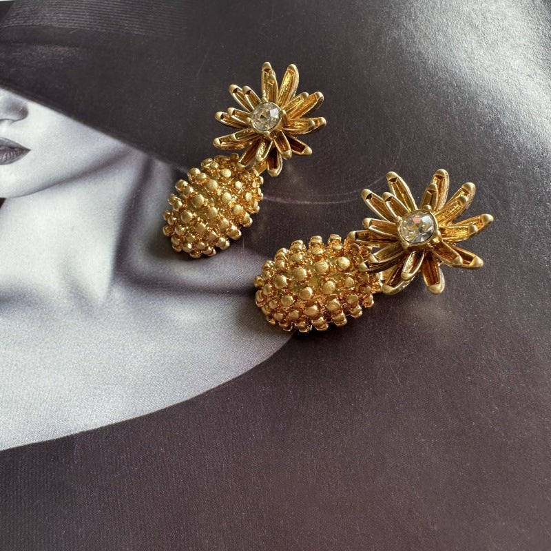 Enamel flower and pineapple diamond earrings with gold flower tops and clear stone centers.