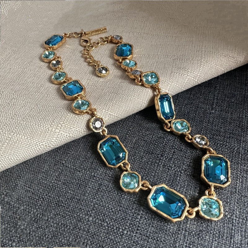 Square crystal pendant necklace with blue faceted square crystals and gold-toned chain