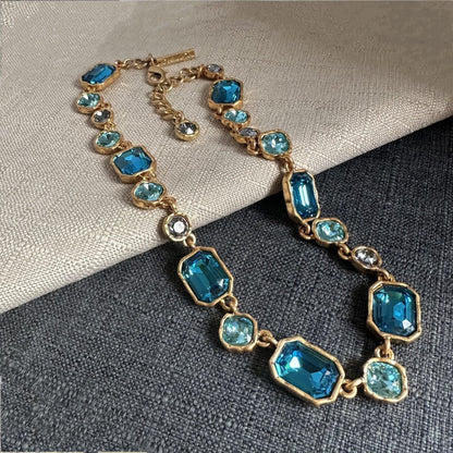 Square crystal pendant necklace with blue faceted square crystals and gold-toned chain