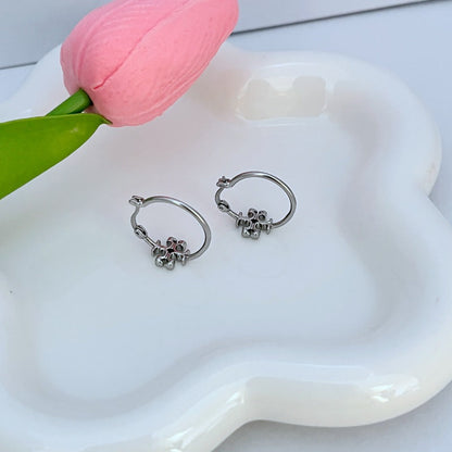 Silver-tone mini hoop earrings with logo charm, side view showing clasp