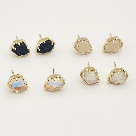 Assorted rhombus stud earrings with dark blue, black, blush, and iridescent stones in gold-tone