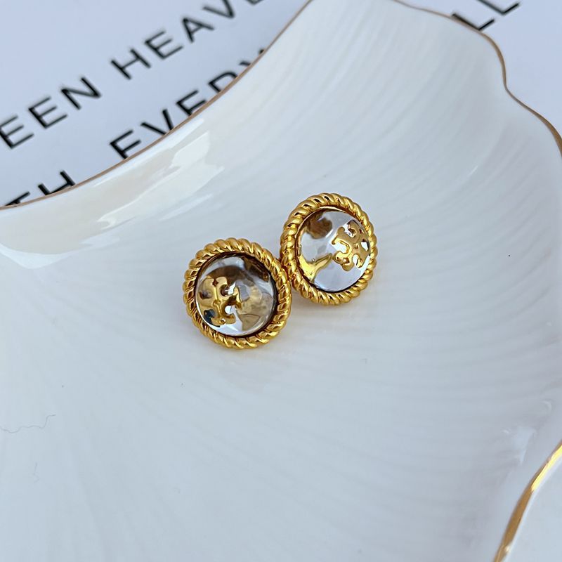 Round gold-tone stud earrings with filigree edge and logo medallion centers