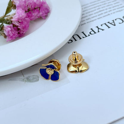 Tory Burch enamel camellia stud earrings in blue with gold-tone backing posts