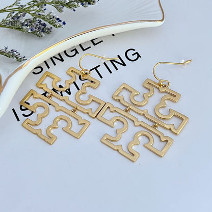 Gold geometric drop earrings with dangling openwork logo panels and fishhook hooks.