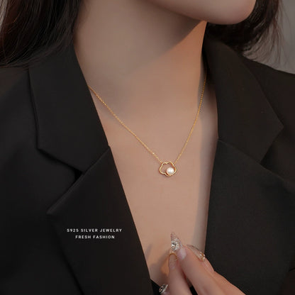 Gold-toned sterling silver necklace with cloud pendant and pearl at neckline