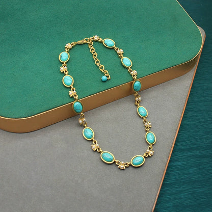 Vintage turquoise oval glass necklace and dangling earrings with gold bow and pearl accents