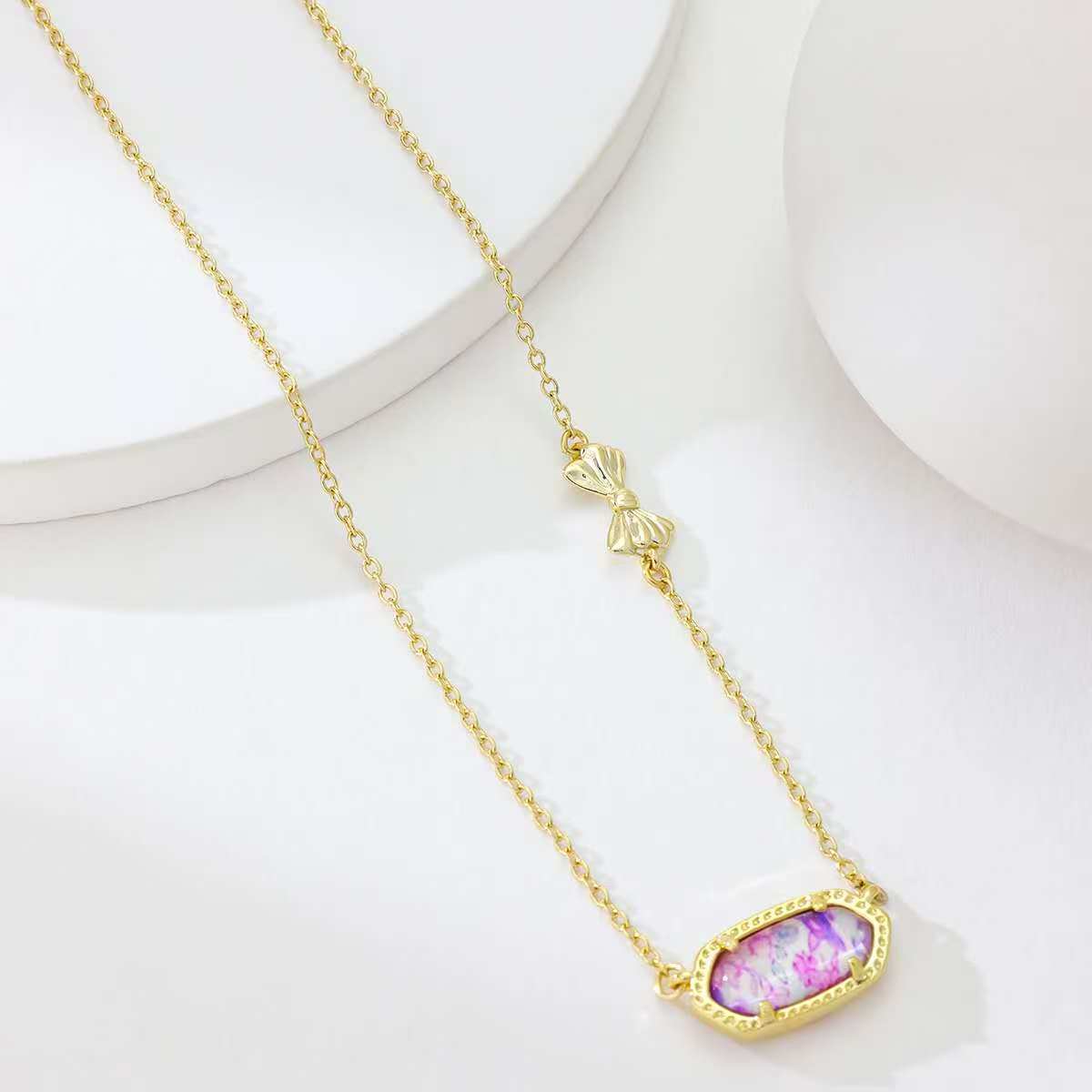 Gold butterfly pendant necklace with oval purple enamel pendant and butterfly charm