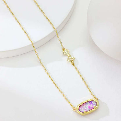 Gold butterfly pendant necklace with oval purple enamel pendant and butterfly charm