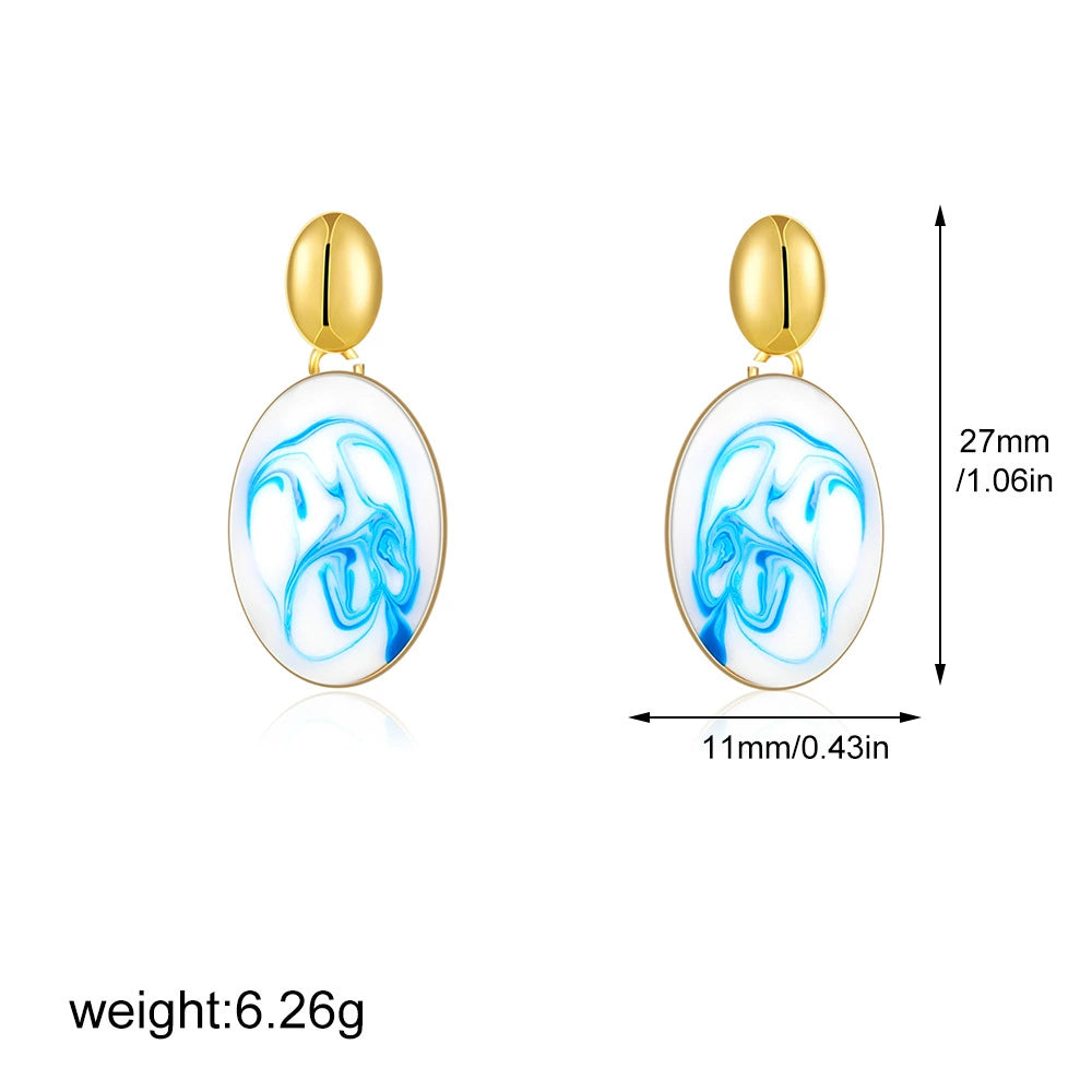 Gold-tone oval drop earrings with blue marble swirl inlay