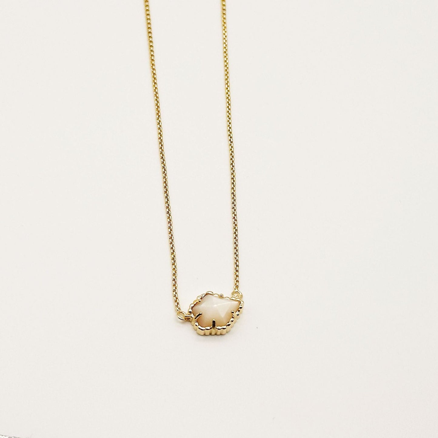 Kendra Scott gold-tone mother-of-pearl necklace with light iridescent rhombus pendant