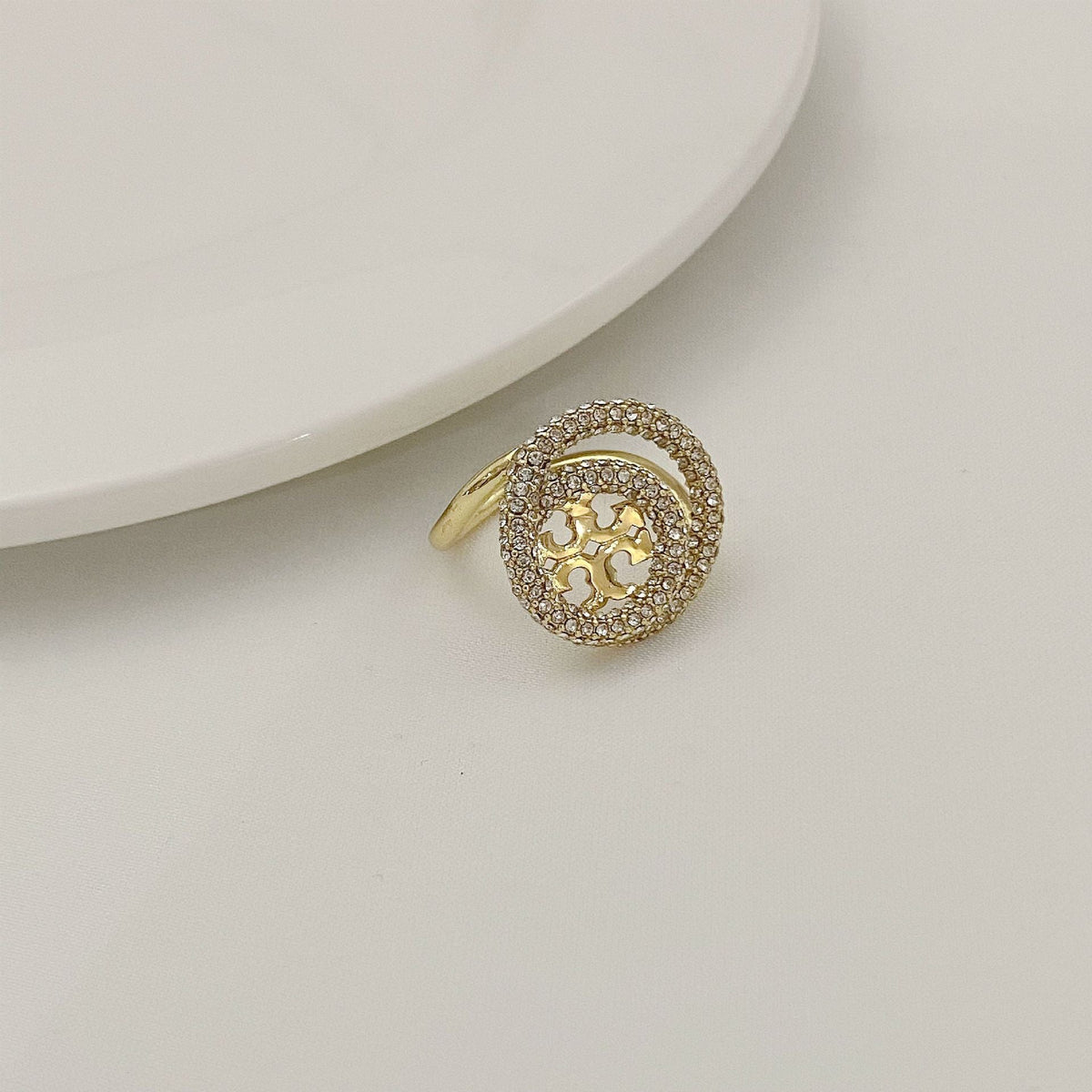 Gold-tone round double-band ring with micro-paved stones and starry cutout centerpiece.