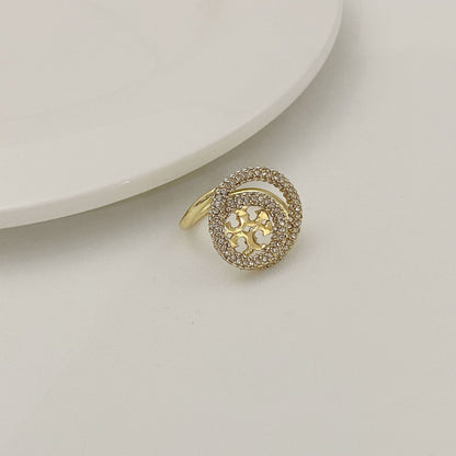Gold-tone round double-band ring with micro-paved stones and starry cutout centerpiece.