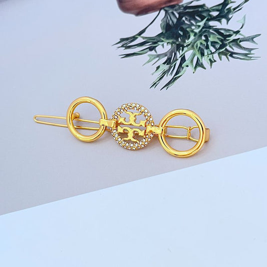 Runder Haarclip in Gold mit Diamantbesatz und zweifacher Klammer-Optik