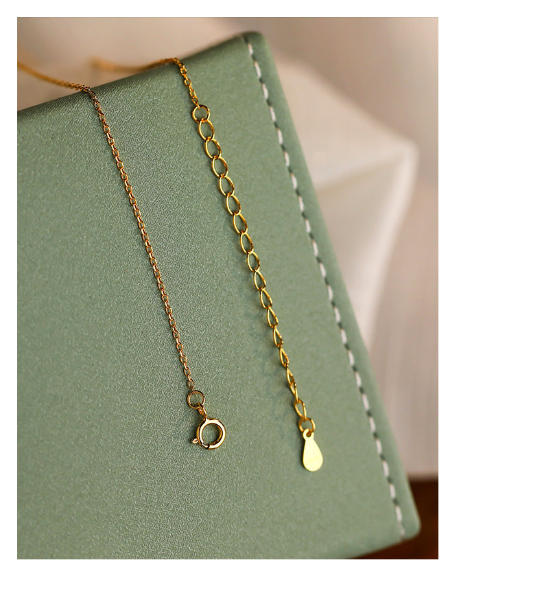 Gold and silver-toned necklace chains with small link details, clasp close-up