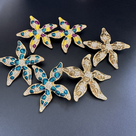 Starfish flower earrings with turquoise, purple, and yellow enamel; rhinestone inset