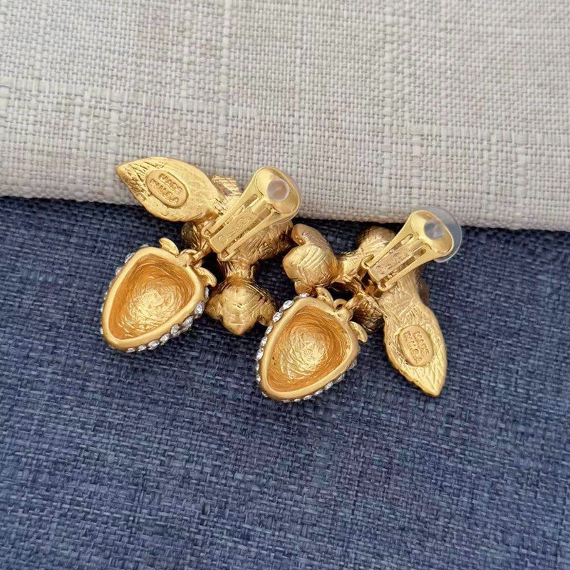 Gold-tone clip-on earrings with articulated back clip and strawberry charm details
