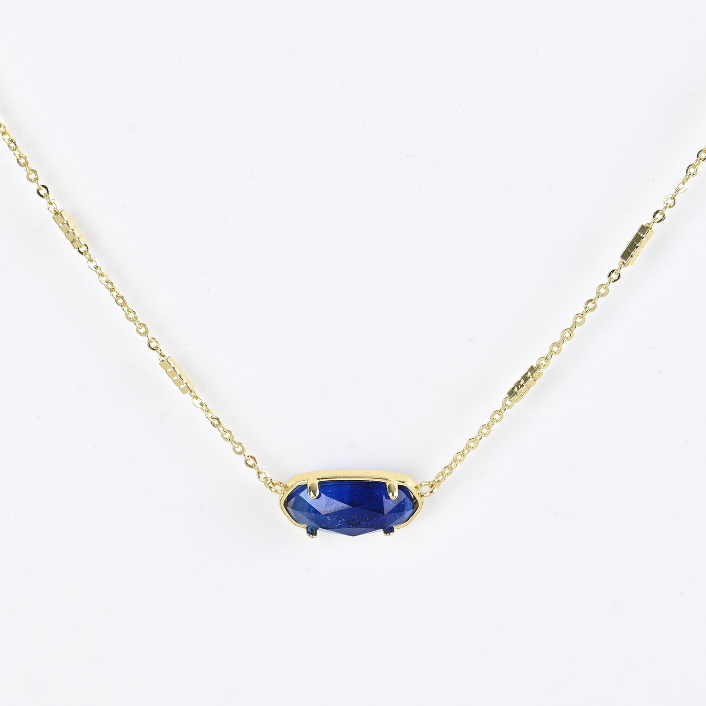 Oval crystal necklace with gold-tone chain and dark blue oval stone