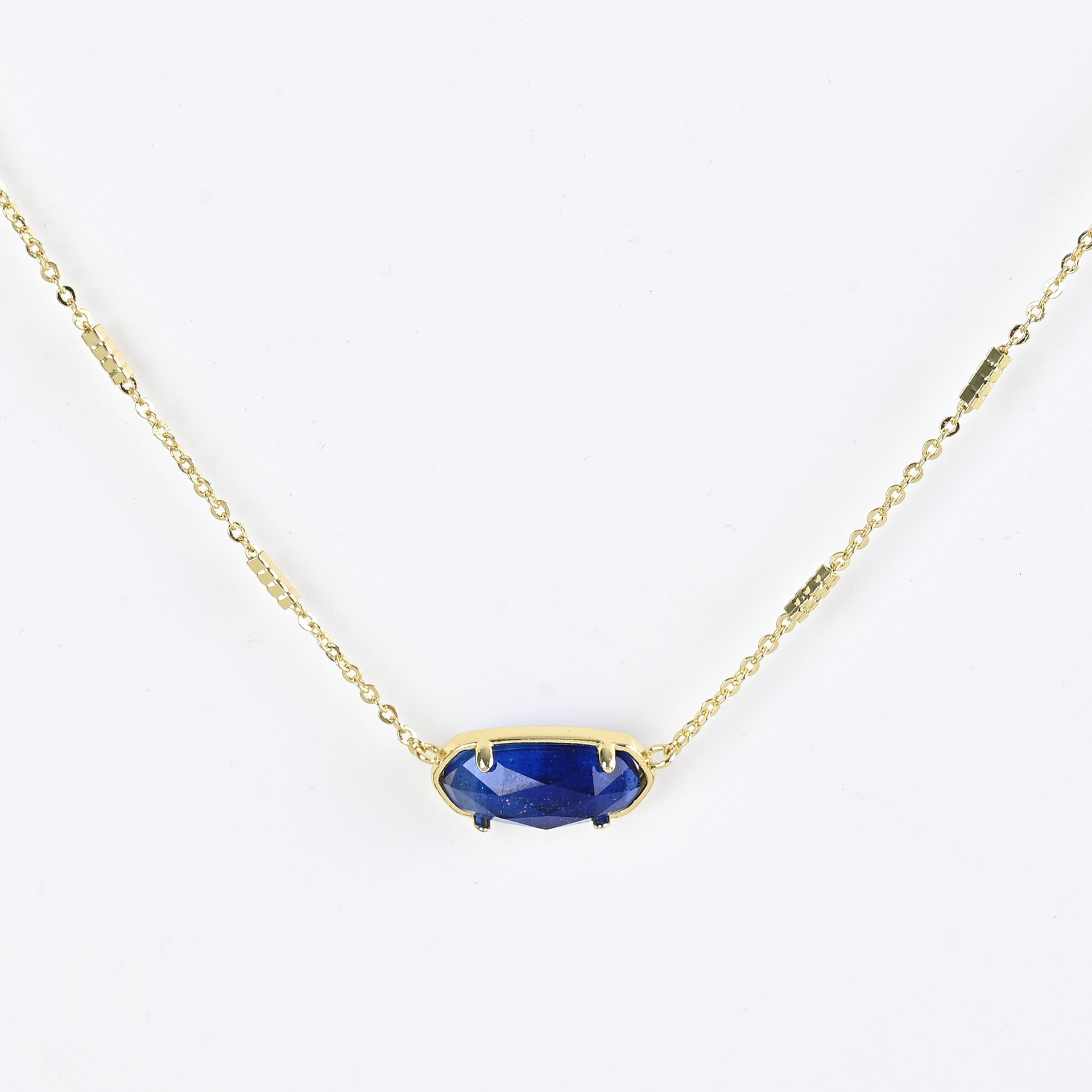 Oval crystal necklace with gold-tone chain and dark blue oval stone