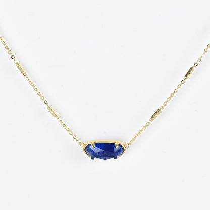 Oval crystal necklace with gold-tone chain and dark blue oval stone