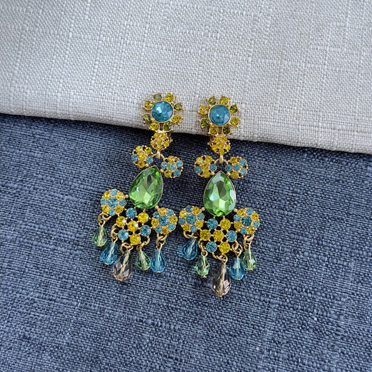 Long clip-on rhinestone tassel earrings with green, blue, and gold stones