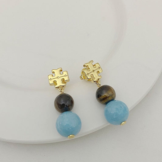 Tory Burch logo pendant earrings with round dark and light blue agate beads